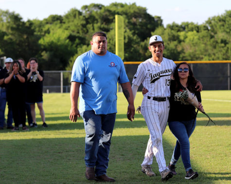 Dominic Alvarado escorts his parents on to the field before the pregame senior night ceremony. The ceremony recognized the season players before their last home game of the season. 