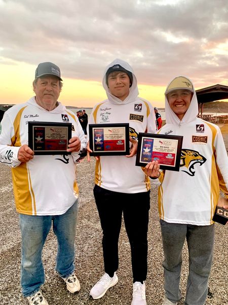 Trace Jansen and Riley Kudelka, along with their boat captain, show of their awards at a district tournament.