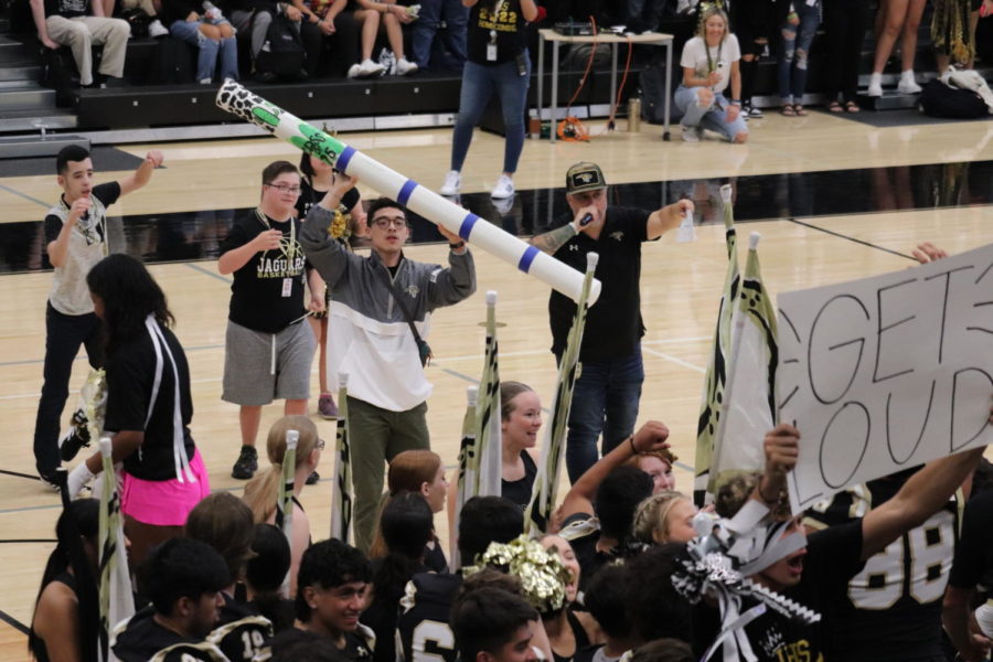 Micah Petrea hypes up the student section at the homecoming pep rally before giving away the spirit stick.