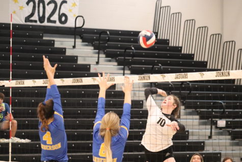 Senior Lauren Tietz makes a spike to secure a close 3-1 set game against Anderson.