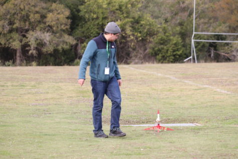 Engineering teacher Bryant Griesel prepares to launch a students rocket during class. 