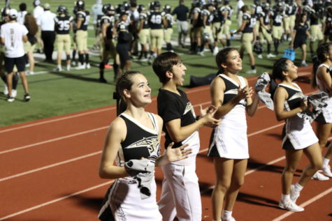 Cheer captain, Ashtyn Williams, cheers on the sidelines of a football game. 