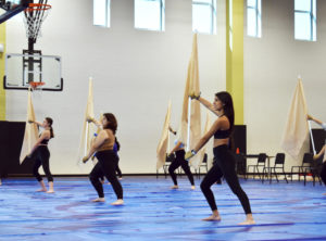 Varsity color guard practices their routine. 