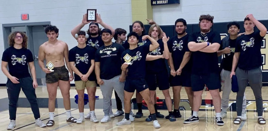 The boys powerlifting team poses for a photo after winning first place as a team. 