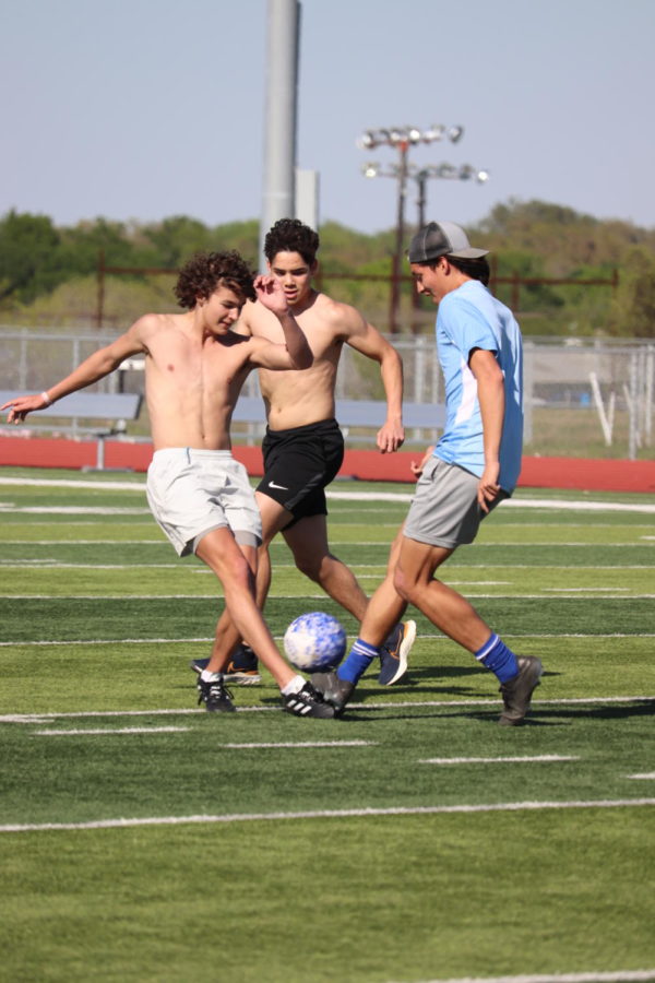 Junior Hayden Huesser and seniors Jorge Galvan-Puente and Tommy Villegas-Palacios fight for the ball. 