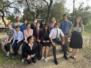 The debate team outside their latest competition. 