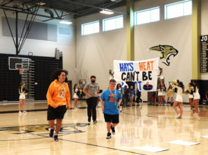 Johnson athletes entering the gym at their pep rally. 