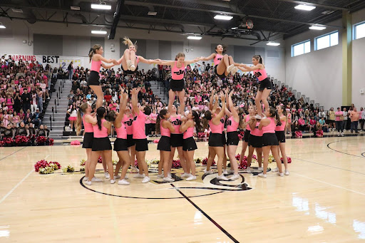 JHS cheer team performing at pink-out pep rally.