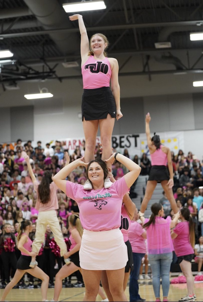 At the pink out pep rally, teachers participated in stunts with the cheerleaders before the pie in the face occured.