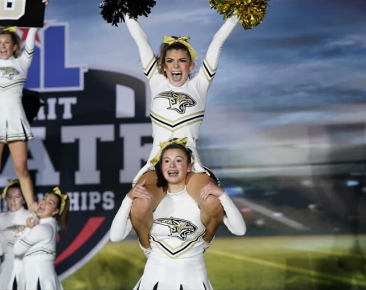 The Beginning of the Competition: Freshman Alexis Martinez (bottom) and sophomore Makaela Goss (top) during cheer in the prelims performance. The school’s cheer team performed in prelims that morning by starting with their band chant and making it all the way to their fight song successfully, regardless of what the team was feeling individually. “I remember being extremely nervous nervous when I first walked onto the mat because I knew how important our prelims performance was,” Alexis said. “But the second the band chant music started playing, I knew I was just doing what I have been doing since August and my nerves decreased.”

Photo Credit: Avery Humphries