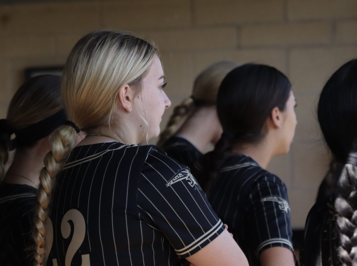 Team Support: Sophomore Bri Kirkup and her teammates look on to the game. She has been playing since she was six years old and loves the community the sport offers. “When I was younger, I thought softball was fun,” Kirkup said. “My parents got me to do it, and I just fell in love with it.”