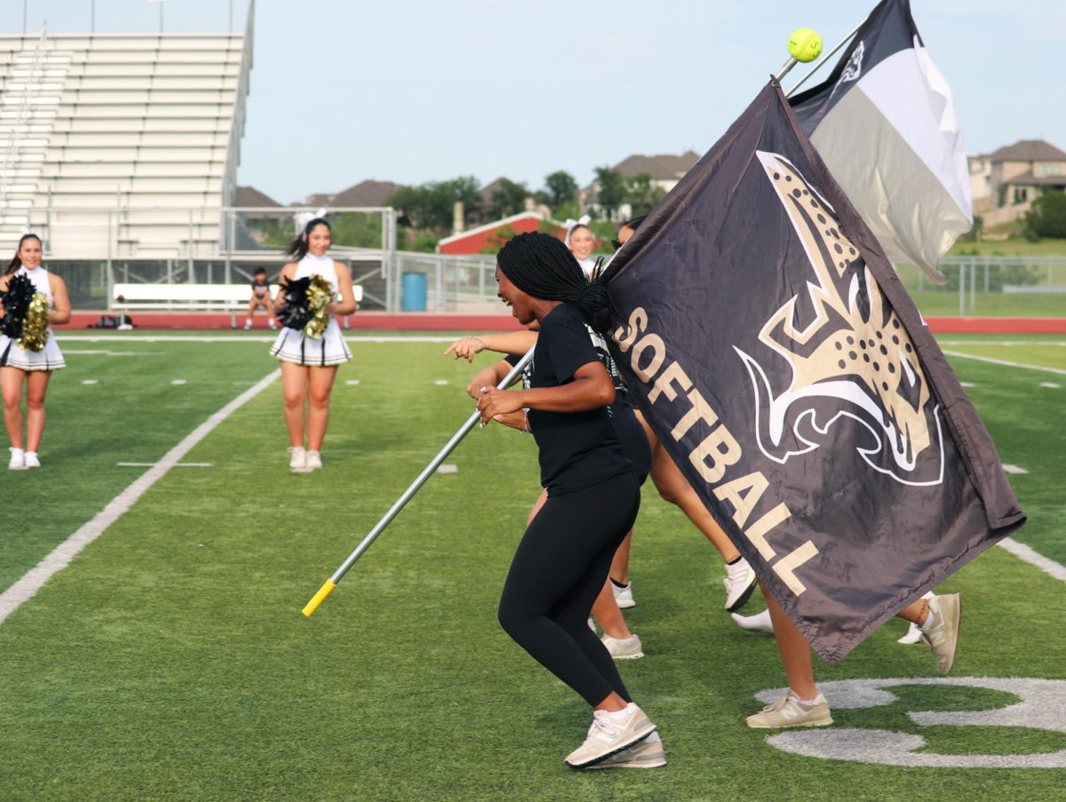 Jag pride: Freshman softball player Malia Young ran onto the field with a flag. “The program enjoyed it because we dont really get recognized for anything, cause its a football school,” Young said. “I think it was nice to include all the sports in it.