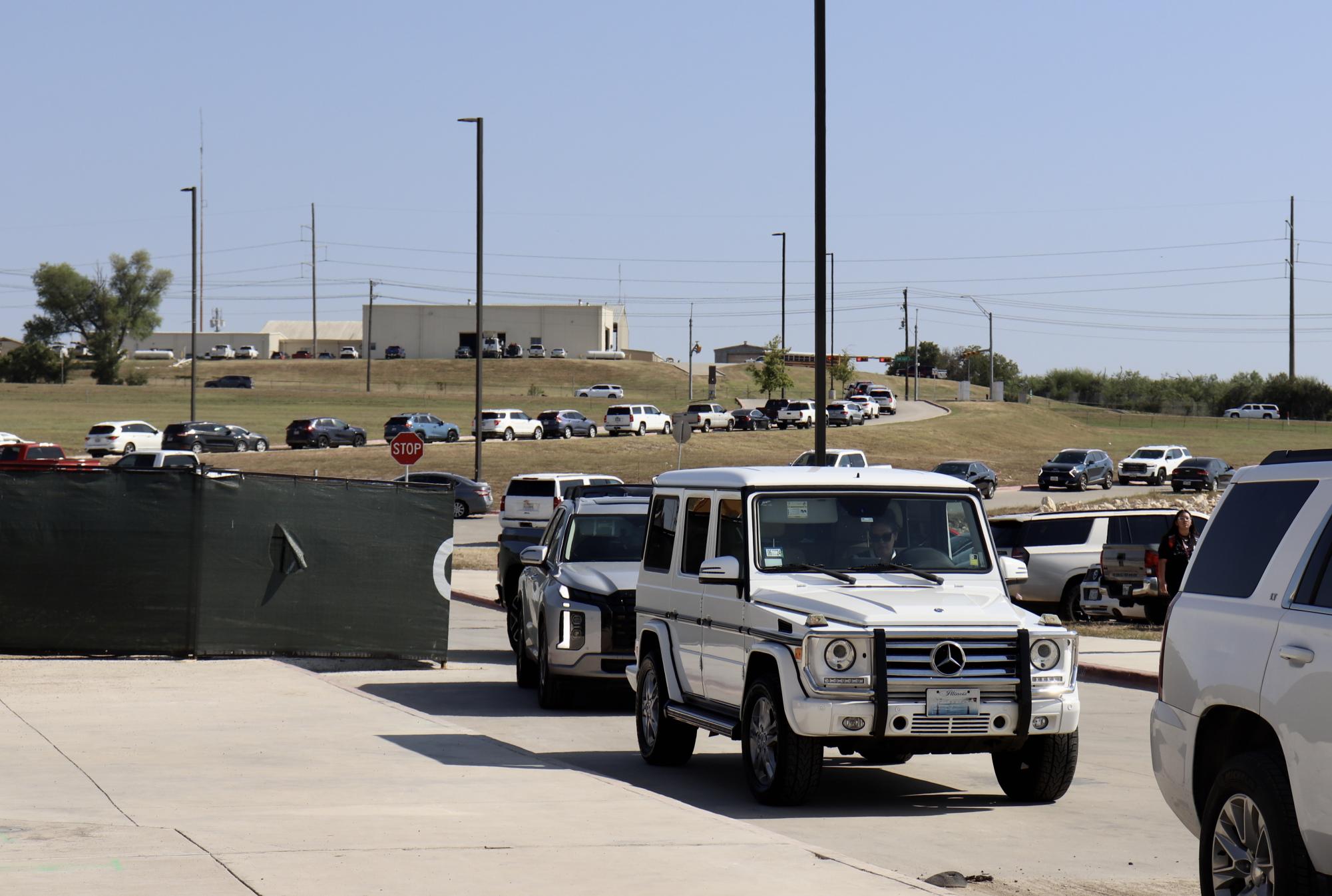 Back of the Line: Cars line up for pickup in the Johnson band and main pickup loops on Aug 21, 2024