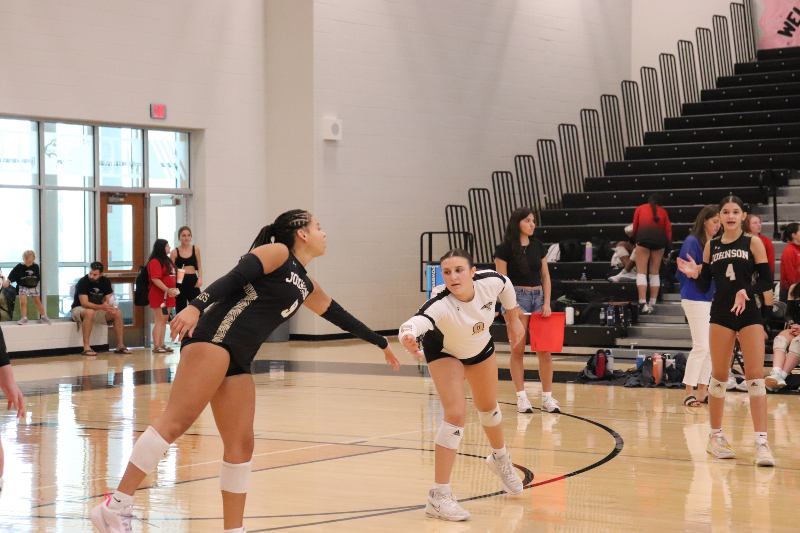 JV volleyball player Maya Mosely and Hudson Reed performing their before-serve ritual. 