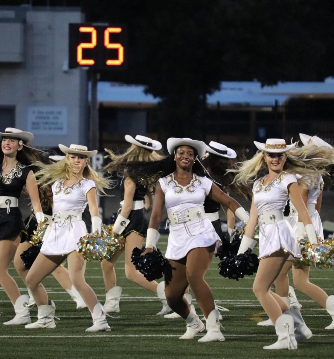 The Rosette President (left) Kiahna Mustain, Co-Captain Addi Lindholm, (middle)Captain Skylar Powell, and (right) First Lieutenant Presley Lowden performing during the halftime show. 