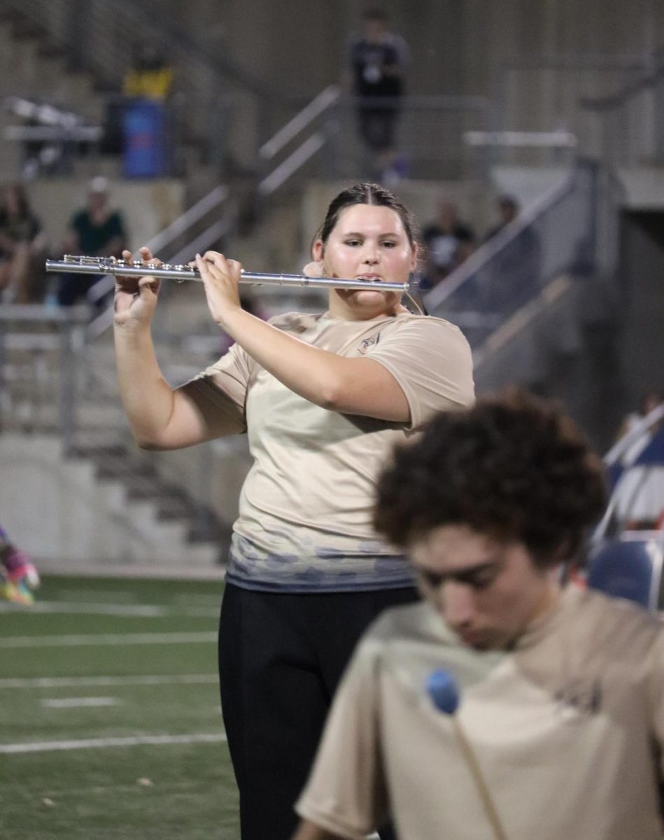 Senior Flutist Carolynn Rheas performing her flute solo during the halftime show. 