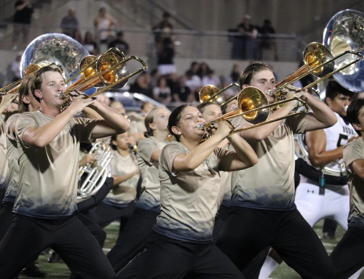 The Marching Band members (left) Joshua Oates, (middle) Makenna Proulx, (right) Zephyr Rainey performing during the marching band. 