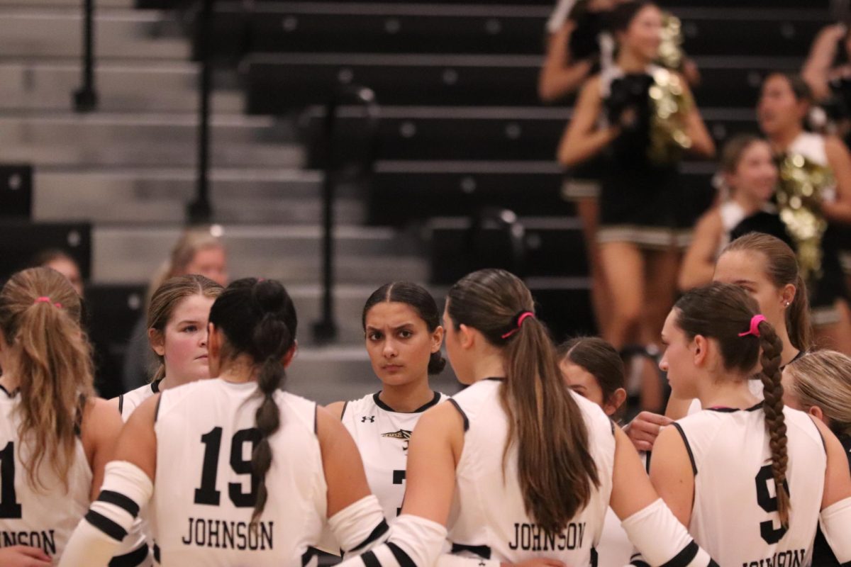 Hailey Hinojosa stares towards audience as the team discusses their next move. 