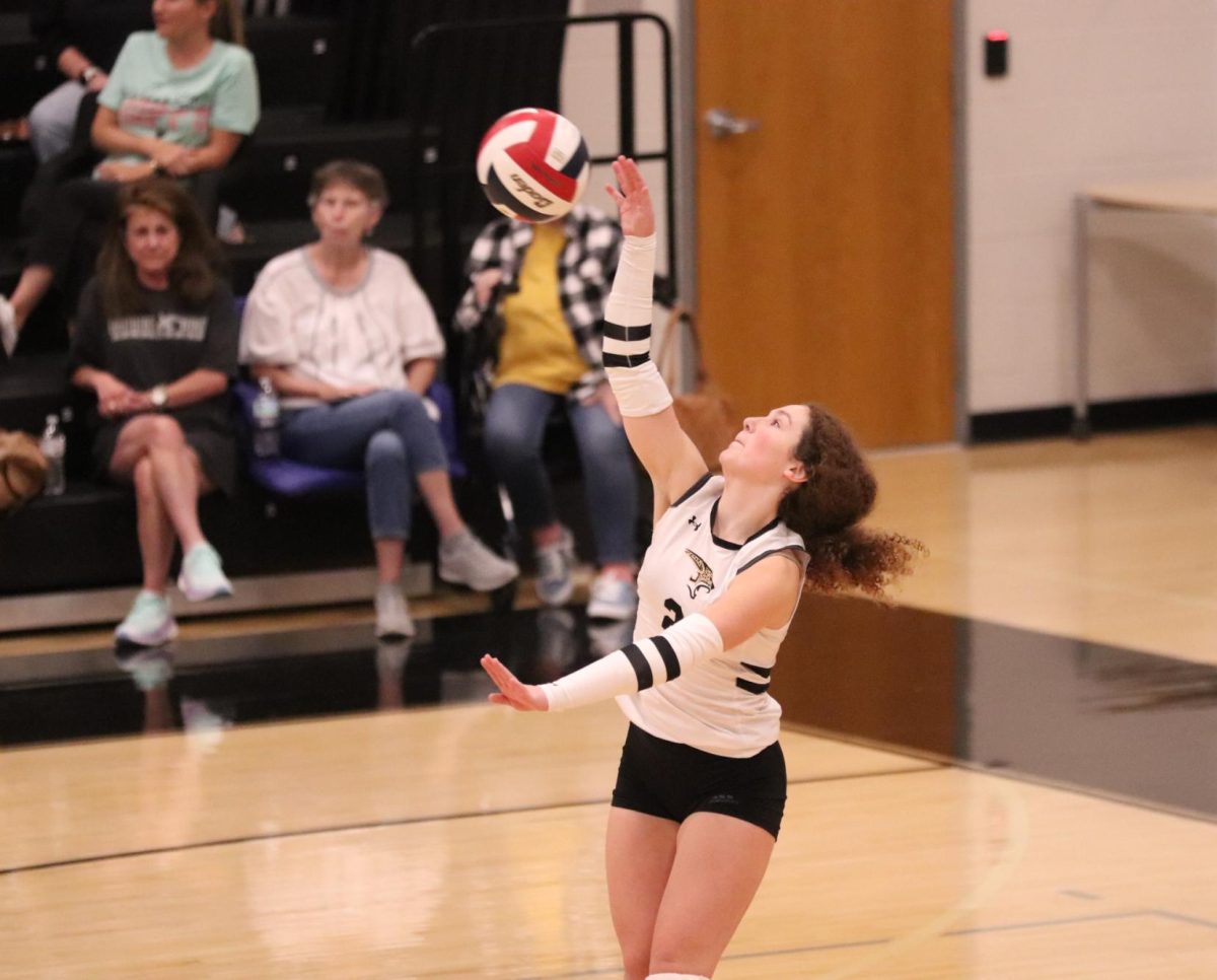 Junior Sophie Haskell serving the ball. 