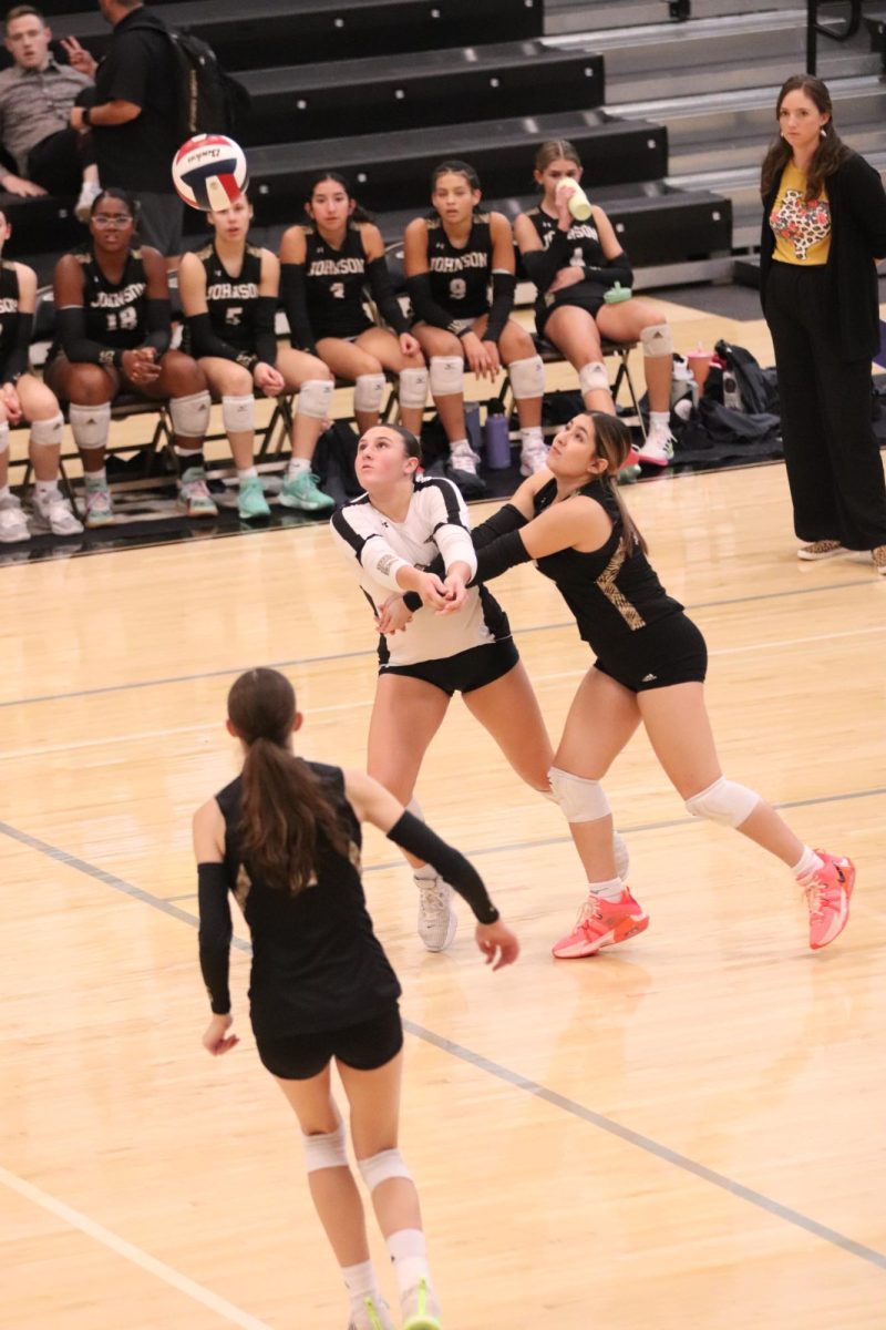 Freshmen Hudson Reed [left] runs into her teammate as they both try to bump the ball. 