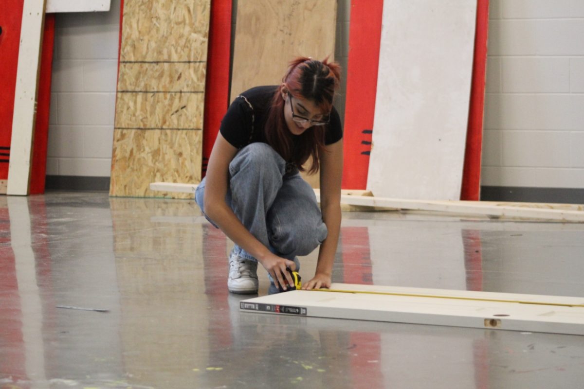 Senior Sofia Gonzalez building a door prop for the production of Clue.
