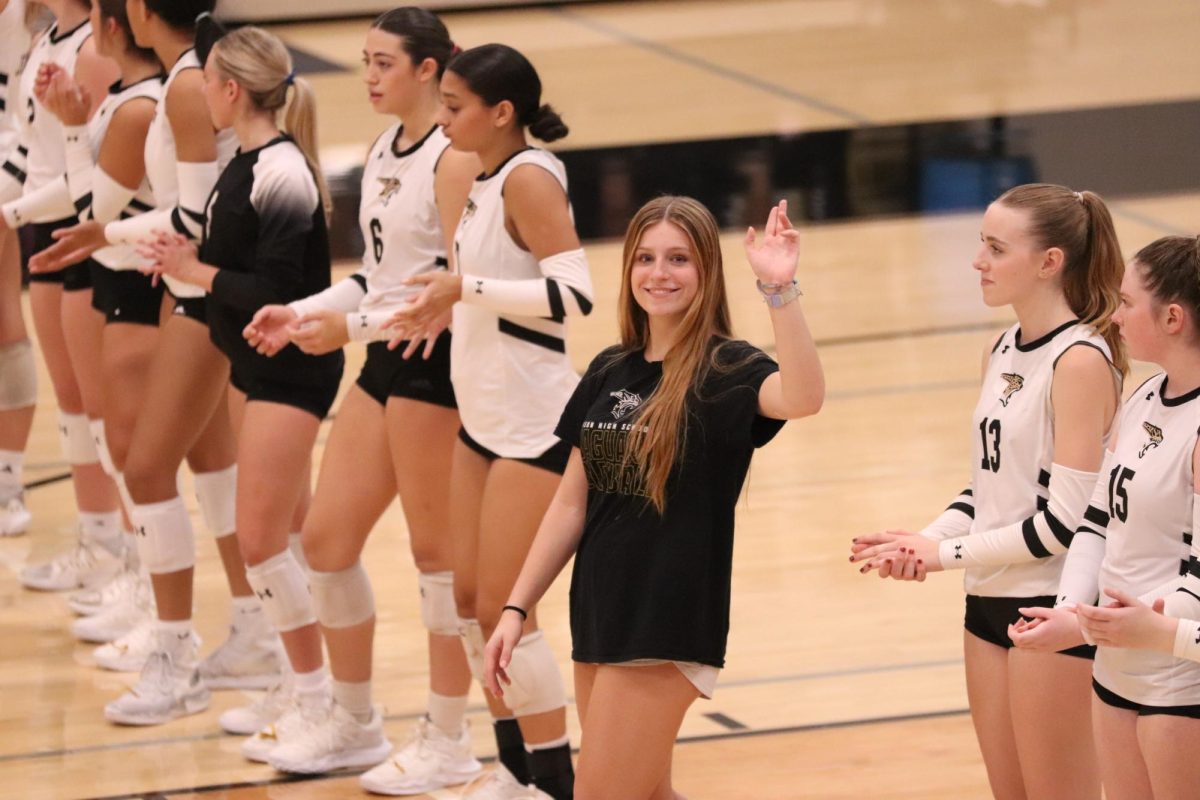 Junior Macy Phillips waving to the crowd. 