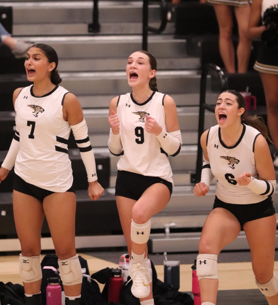 Senior Hailey Hinojosa [left] cheering alongside junior Adaleine Farrar [middle] and sophomore Treycee Creek [right]. 