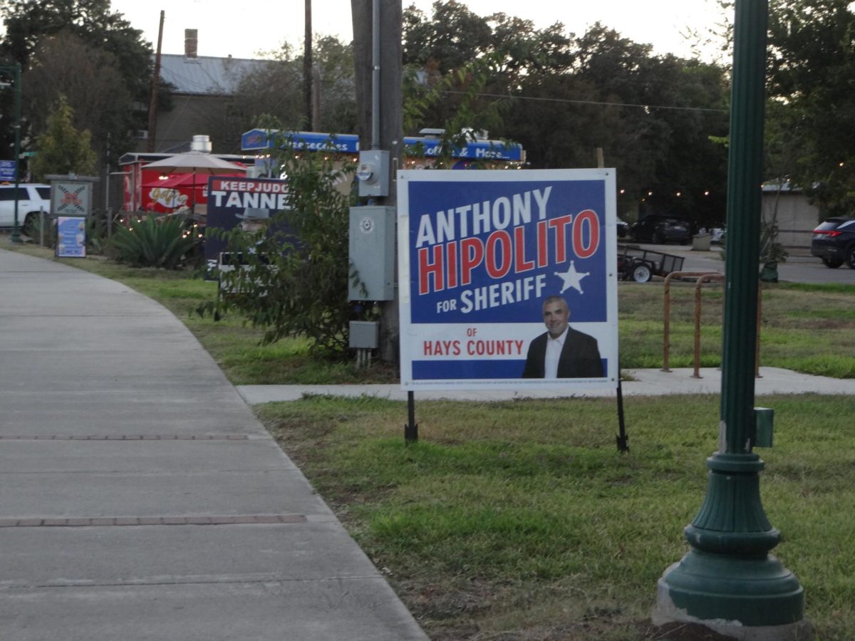 Sheriff candidate sign on Buda Main Street to promote voting in upcoming election. 