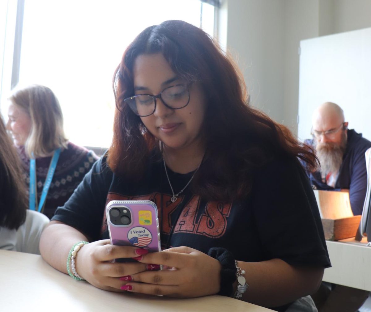 Senior Joanna Mata with an 'I voted' sticker on her phone. 