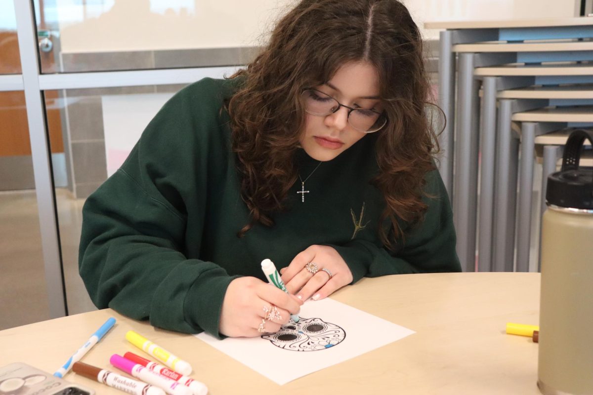 Junior Elizabeth Rhoads coloring a calavera at the club’s monthly meeting on Oct. 23.
