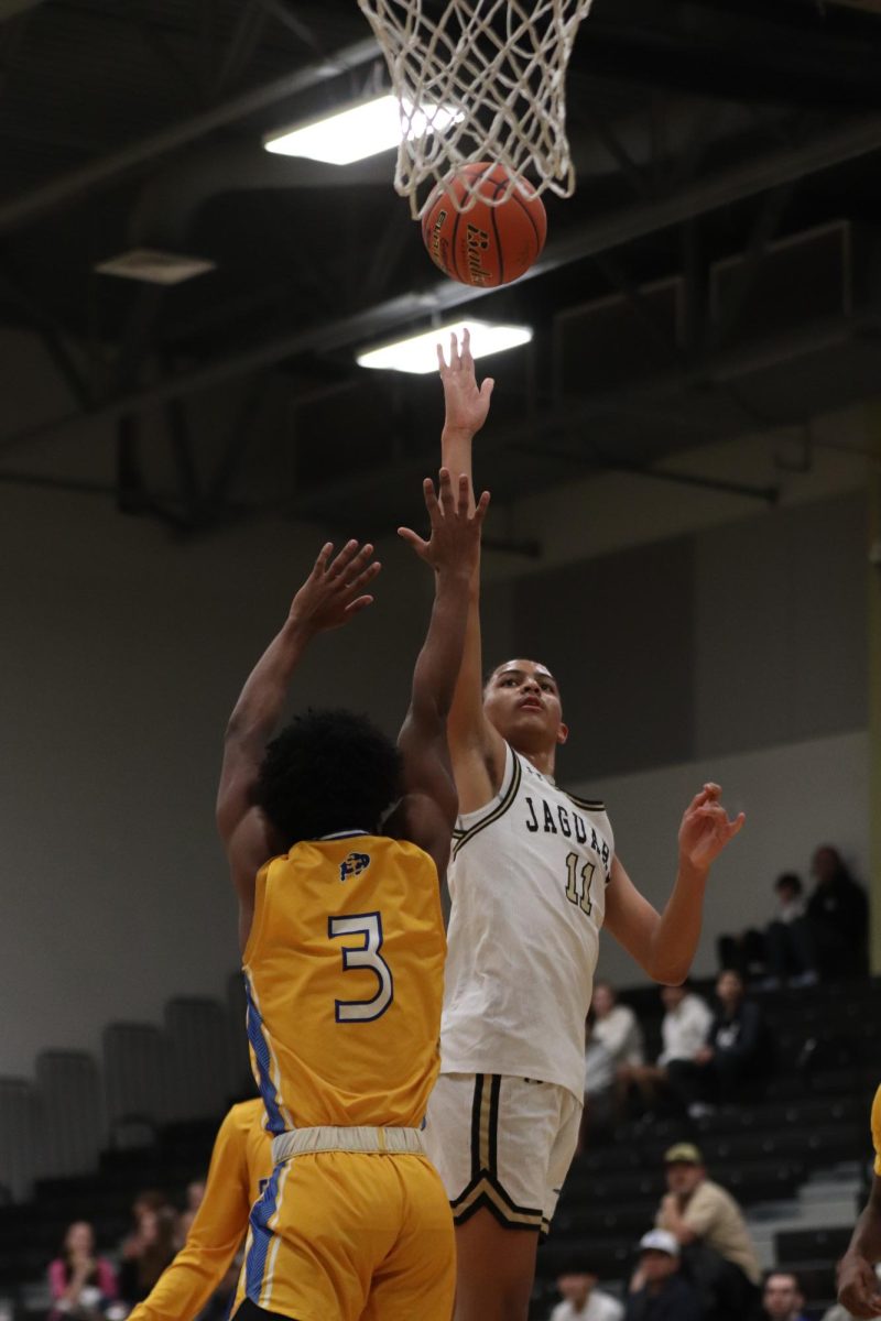 Sophomore Mack Martin throwing the ball into the net for a score. 