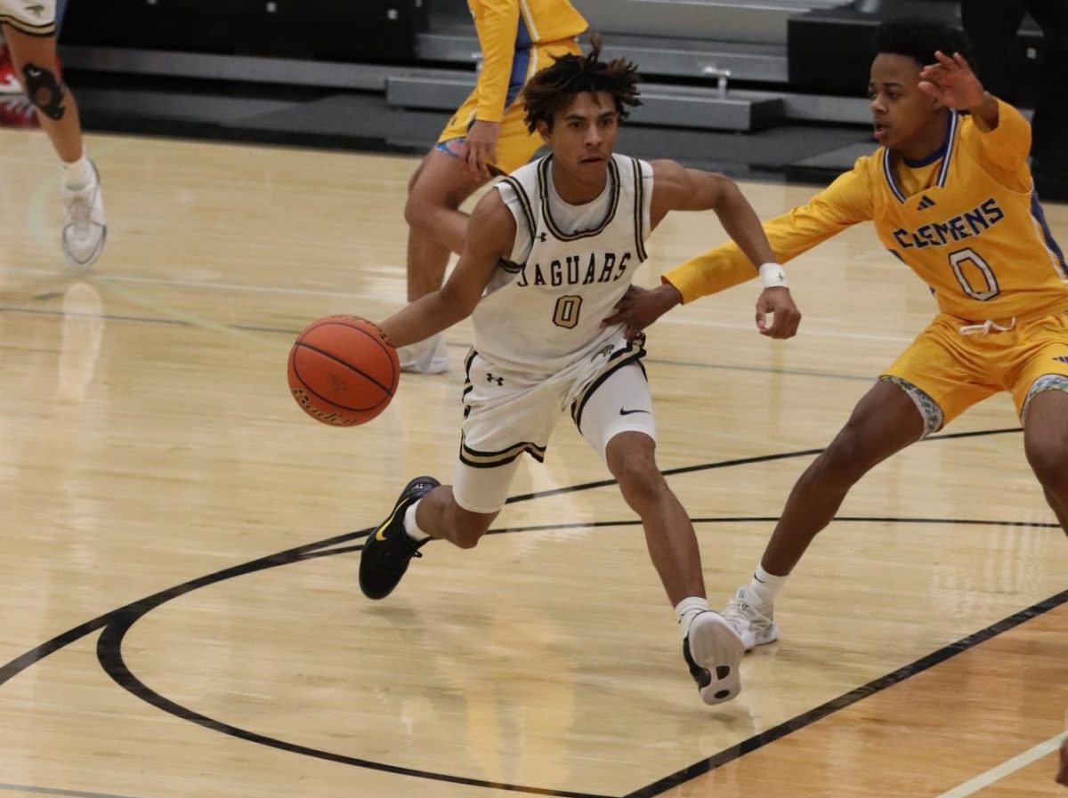 Junior Jayvonne Flores running to the net while dribbling the ball. 