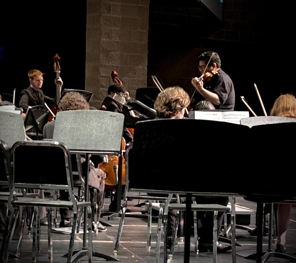 FOLLOW THE LEADER Playing in unison, the JHS orchestra plays their second piece of the night. The performing arts help students focus and works on their attention spans. “In today's world, everyone's attention spans are getting shorter and it's harder and harder to concentrate. With orchestra, you have to really lock in and that has helped me to be able to focus on tasks for long periods,” junior violinist Hazel Barksdale said.