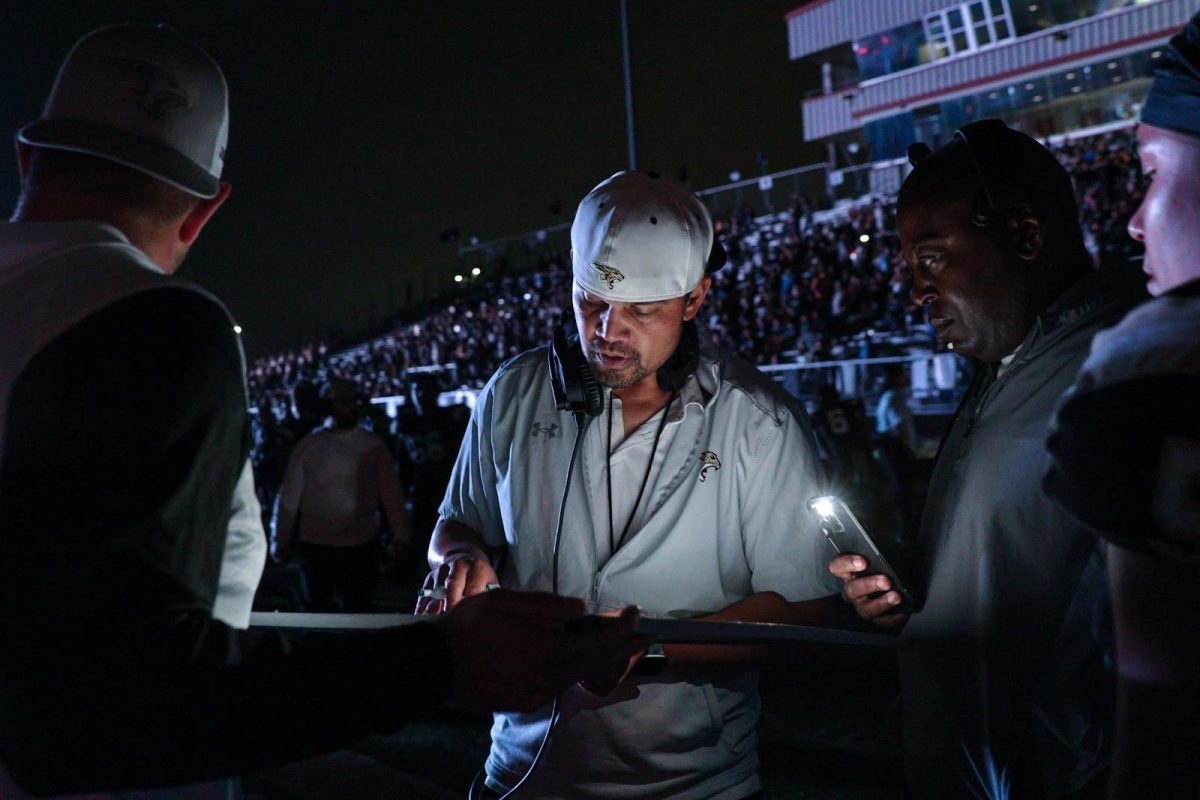 Submitted photo of a coach using a flashlight after the stadium's lights suddenly went out.