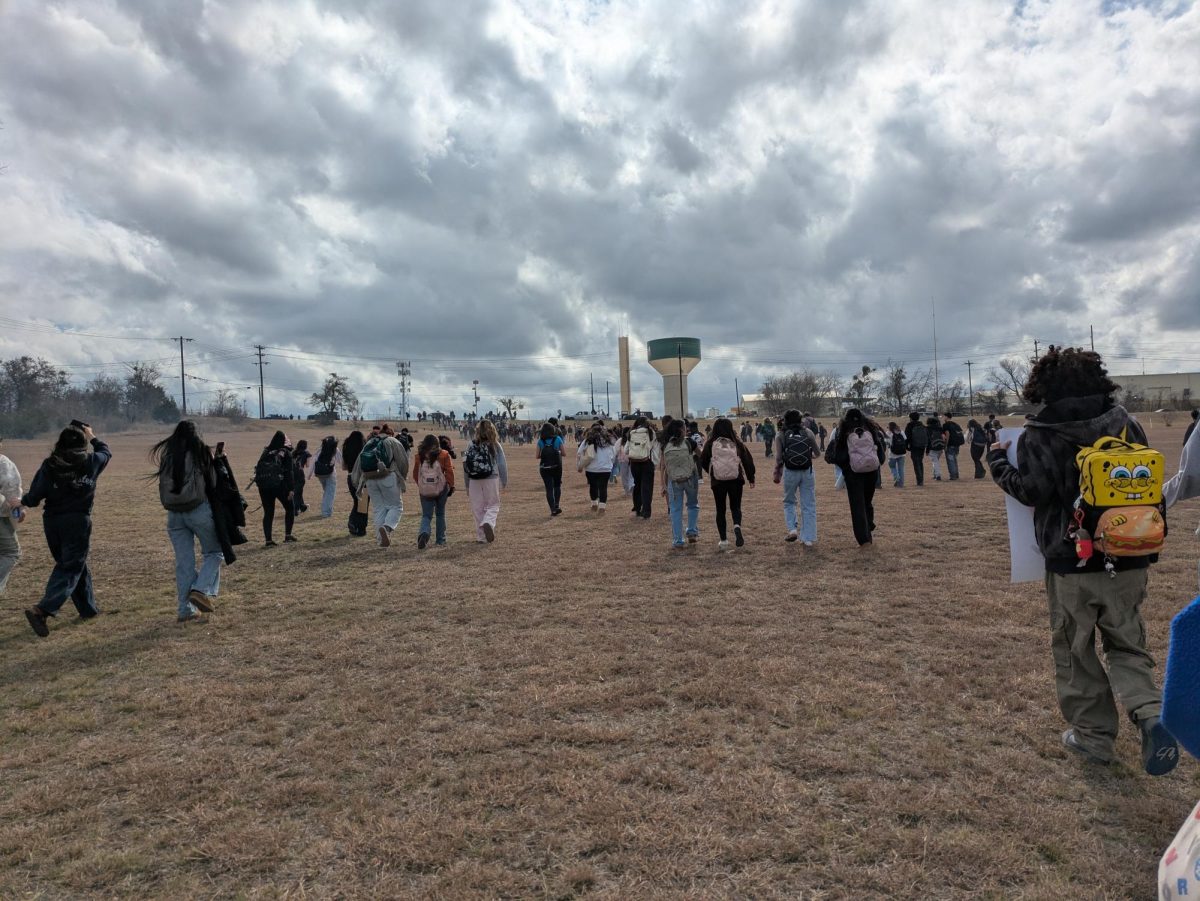 Student protesters walk up the hill in front of JHS to RM 967. 